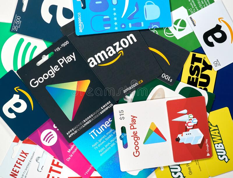 Assorted colorful gift cards for Google Play, Amazon, iTunes, Netflix, and other apps stacked together