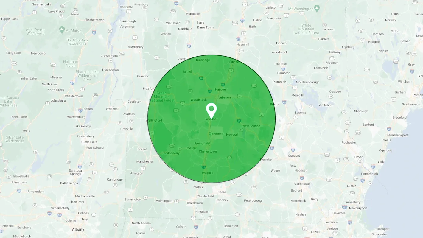 Map with a green circle around a central location, indicating a geographic area.