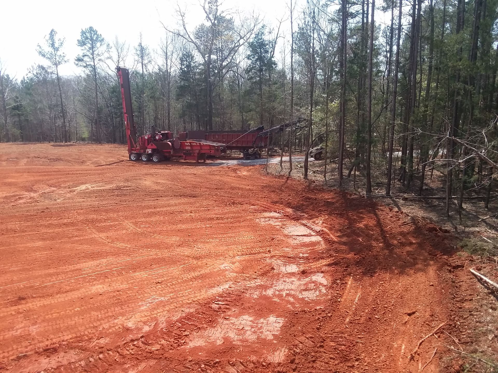 Red Machinery On Cleared Land