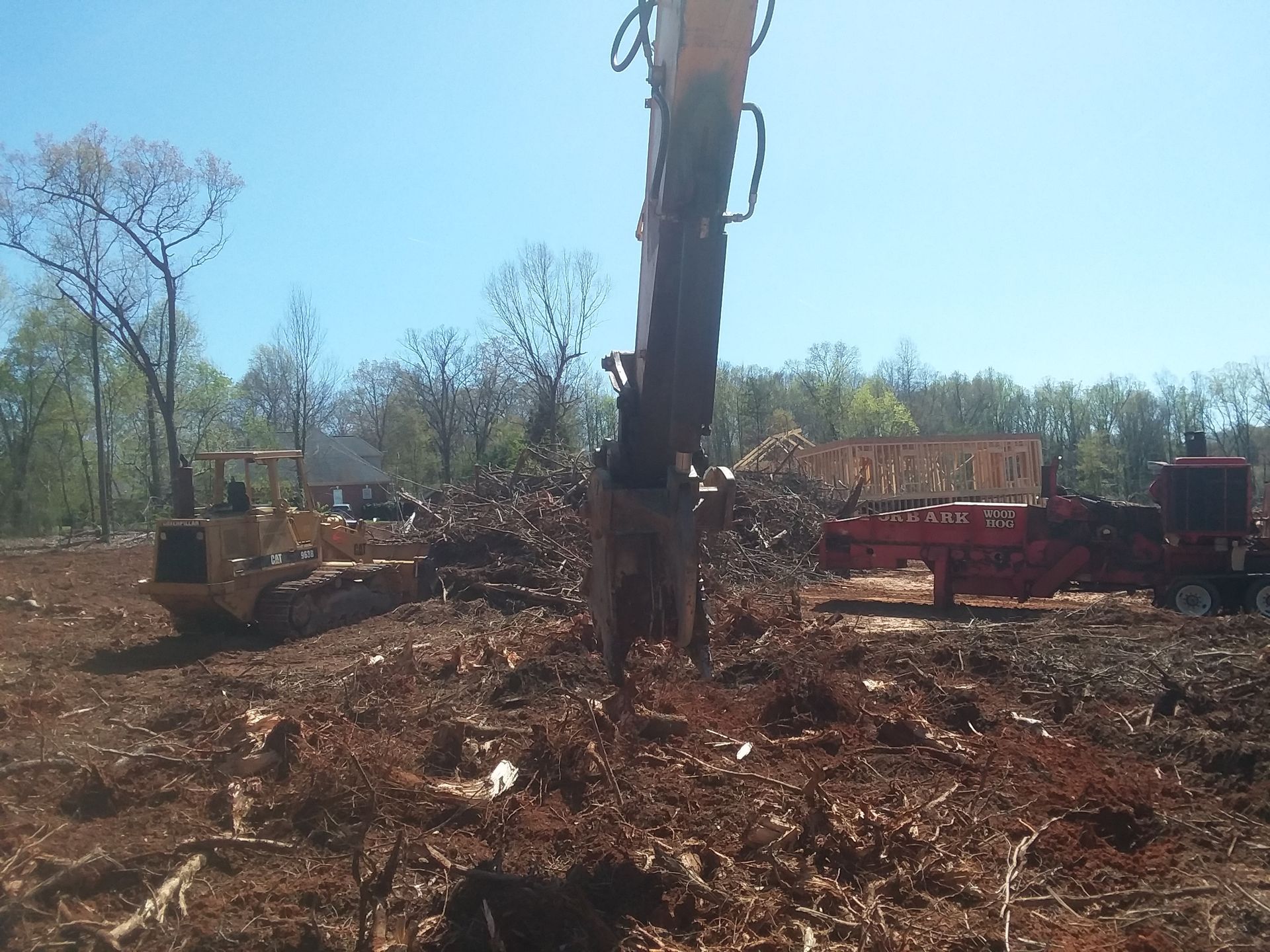 Excavator Clearing Debris On Site