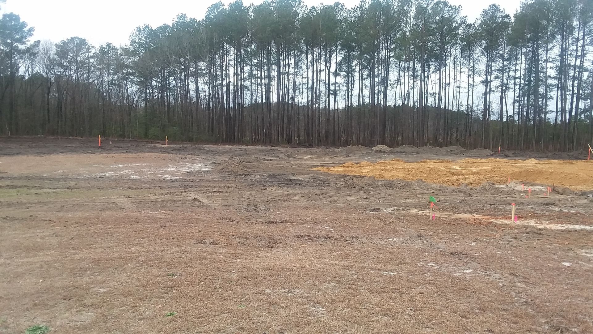 Commercial land being levelled and cleared by two yellow earth moving diggers. Commercial land being levelled and cleared by two yellow earth moving diggers.