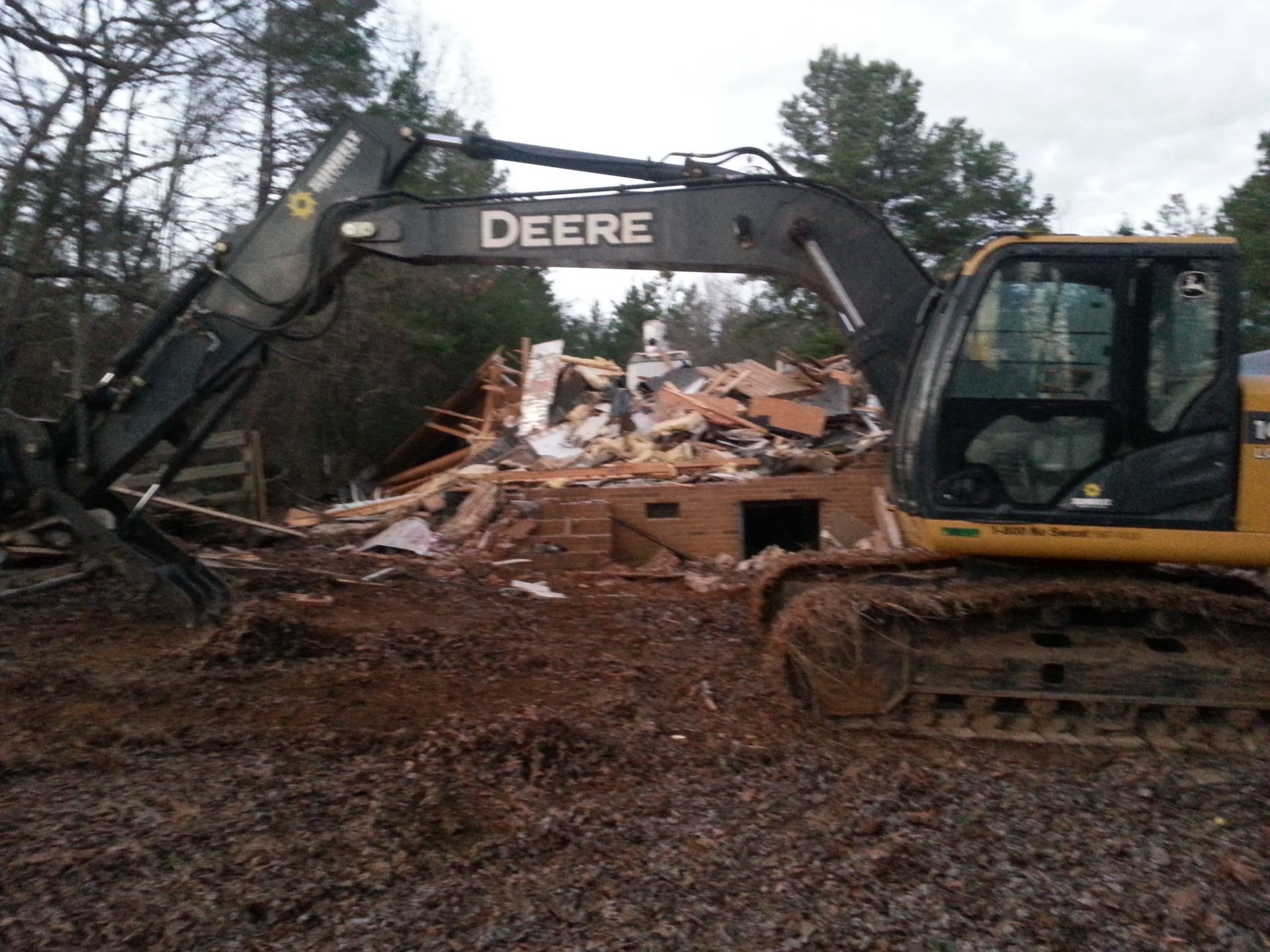 A John Deere Excavator Demolishing A Building
