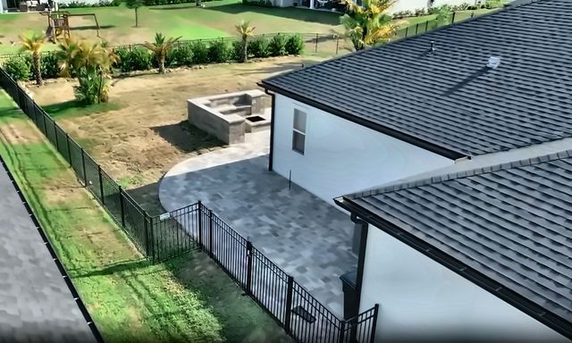Backyard paver patio with curved seat wall and fire pit in St. Augustine, FL