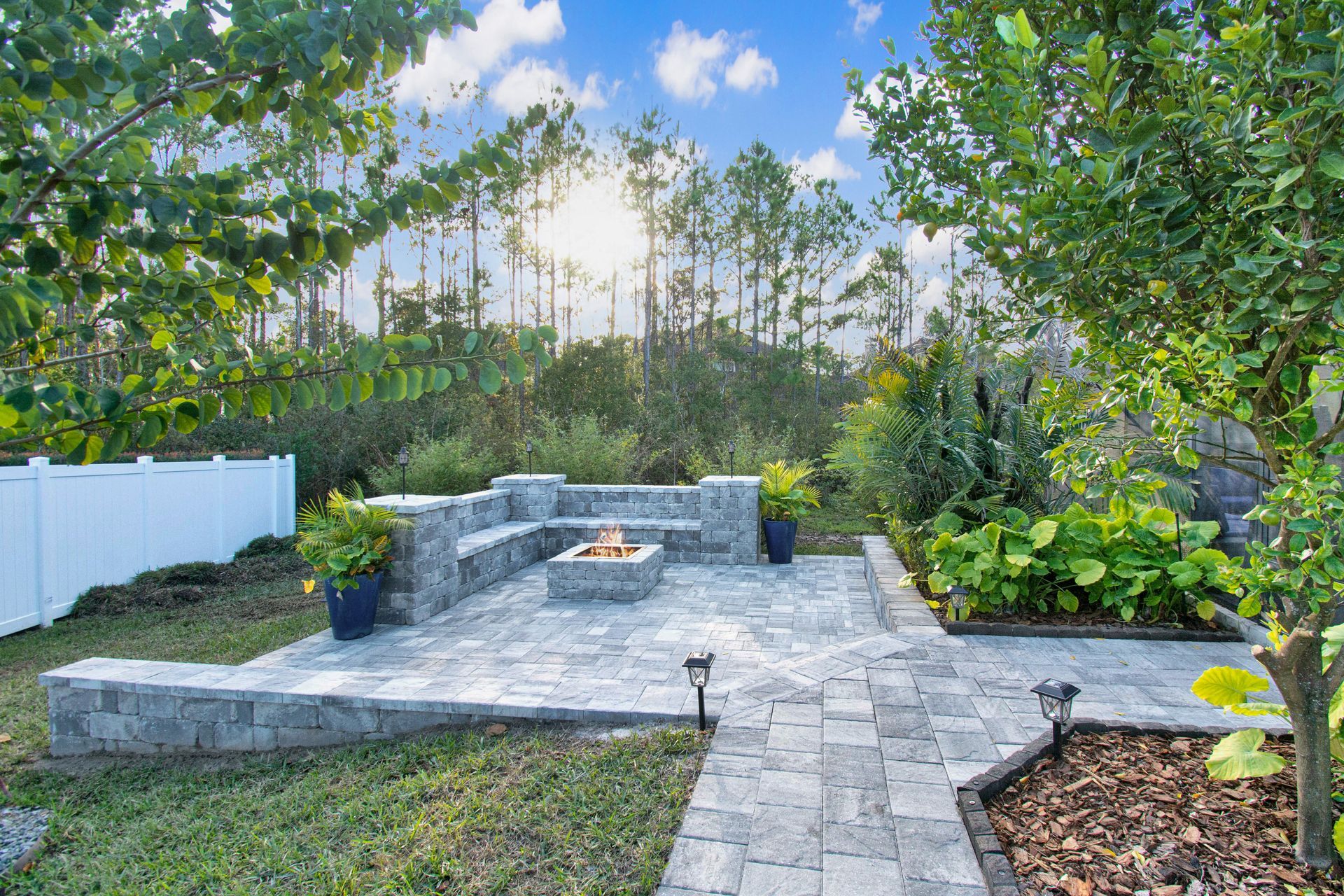 Outdoor Transformations installed a tremron paver fire pit in Ponte Vedra Beach, FL, for a seamless garden path.