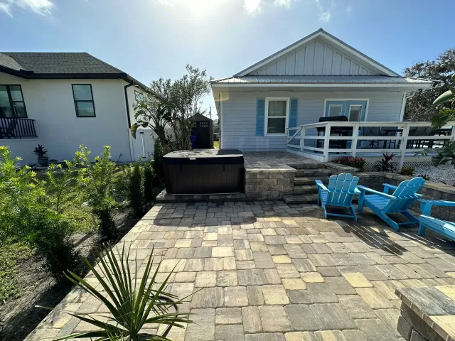 Paver patio with paver fireplace and garden retaining wall in Vilano Beach, FL
