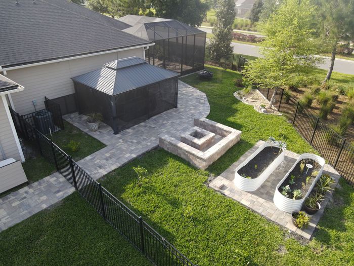 Outdoor Transformations installed a tremron paver fire pit in Ponte Vedra Beach, FL, for a seamless garden path.
