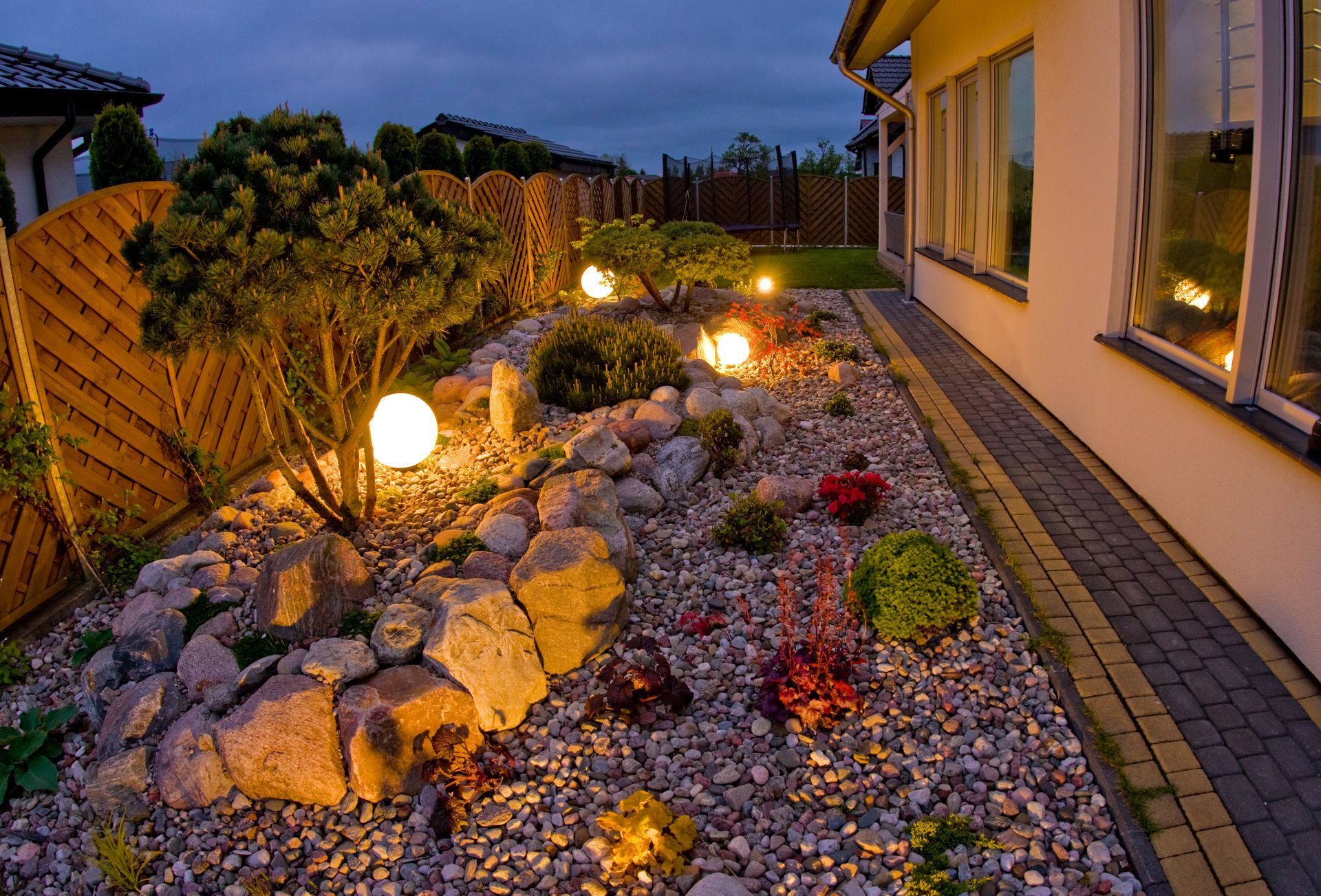 Outdoor Transformations installed garden lighting in Nocatee, FL, highlighting the curves of this beautifully paved patio.