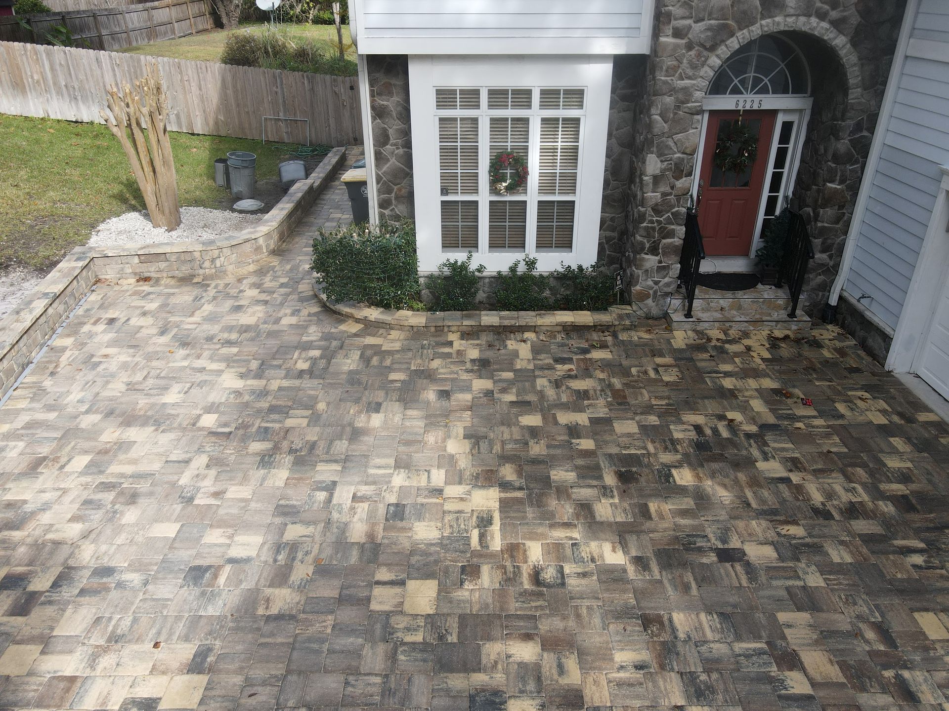 Aerial view of a paved brick driveway leading to a home entrance in St. Augustine, FL, installed by Outdoor Transformations.
