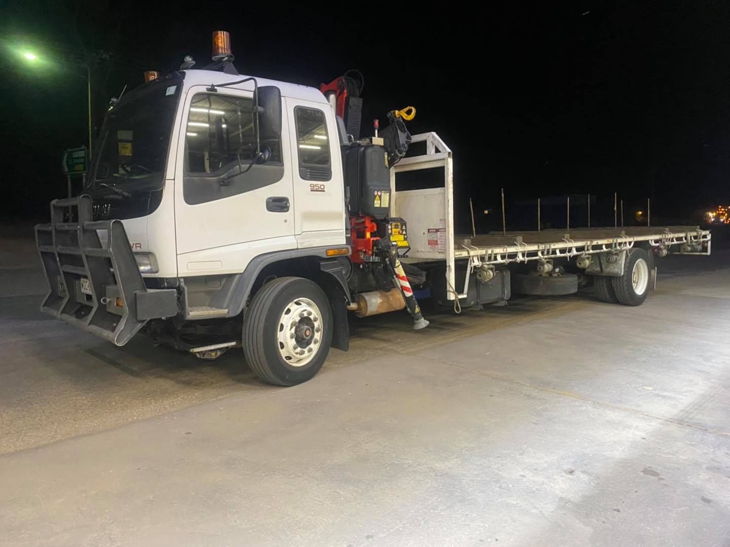 White Flatbed Truck With Crane on a Dark Road — Bob’s Trailer Trash in Yeppoon, QLD 