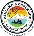Ashland’s Creekside Campground logo with sun, mountains, river, trees, and RV park text, Ashland, Oregon