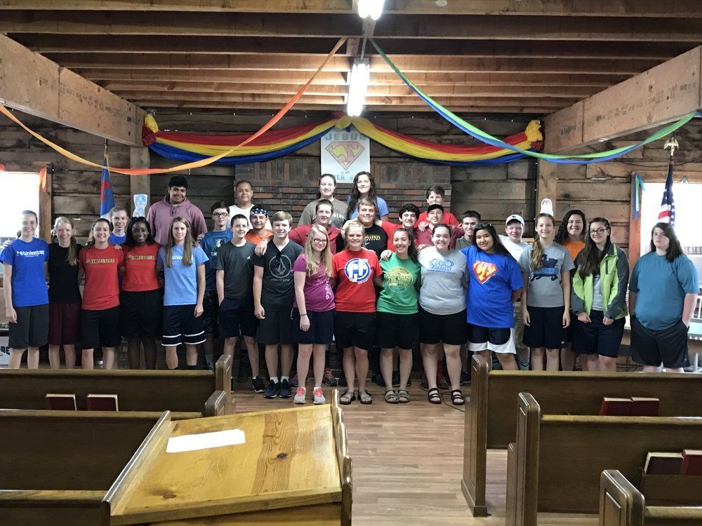 Campers gathered at the front of the chapel among wooden pews