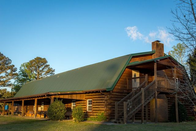 A log lodge with a green roof under a blue sky