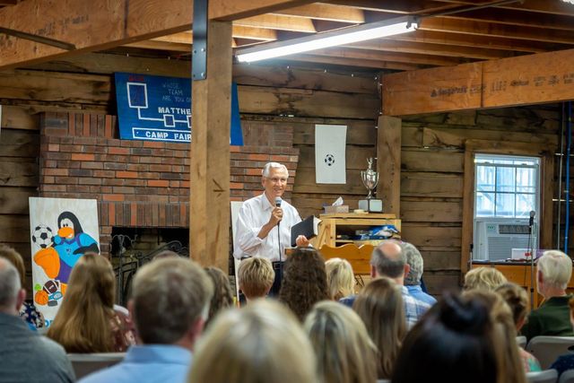 A preacher speaking to a full room
