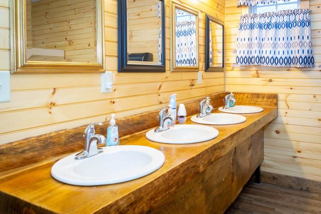 A row of sinks set in a wooden counter
