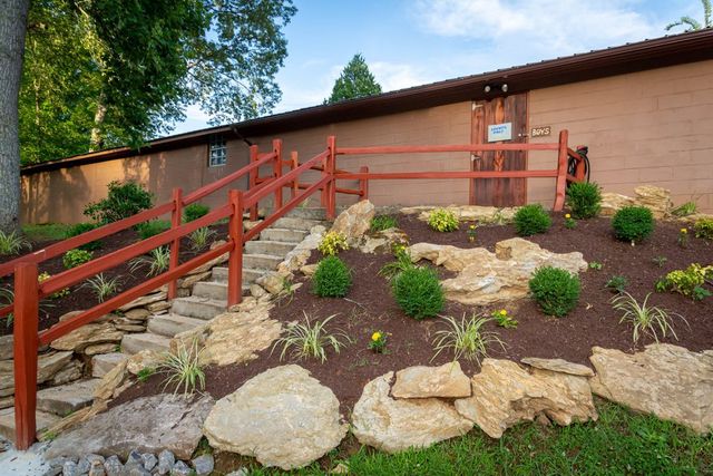 Stone steps and planted beds leading up to a building