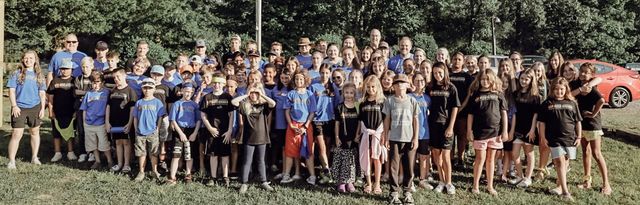 A large group photo of campers on the lawn