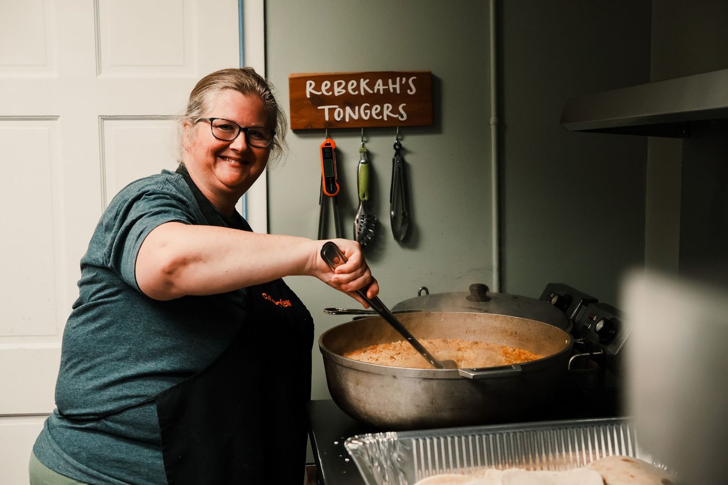 Mrs. Lori Wilson stirring a pot in the camp kitchen