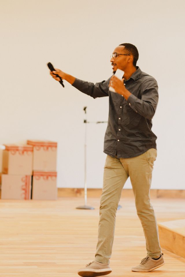 A preacher with a microphone walking the platform