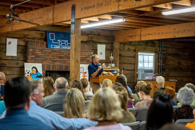 A speaker at the pulpit before a full room
