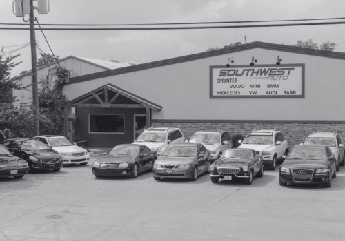 Parking lot outside Southwest Auto with several cars parked in front of the building