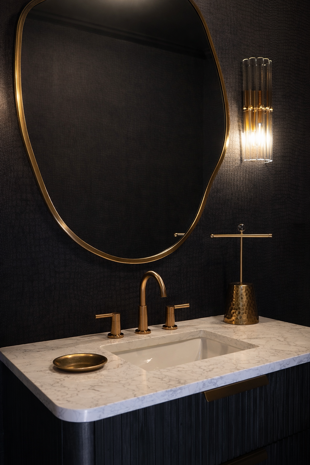 Modern bathroom vanity with dark wood cabinets, white countertop, and illuminated mirror against patterned gray wall
