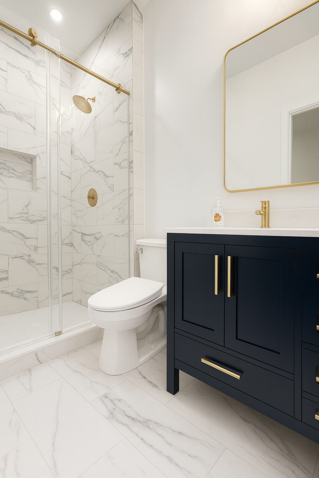 Modern bathroom with white marble tile, black vanity, gold fixtures, toilet, and glass shower stall