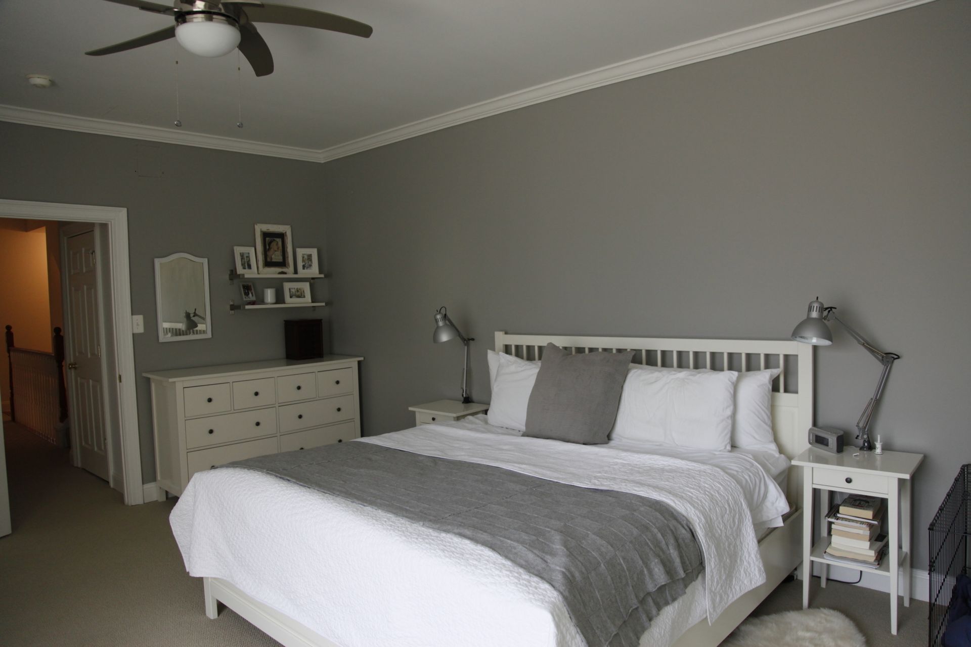 Gray bedroom with white bed, dresser, and bedside lamps