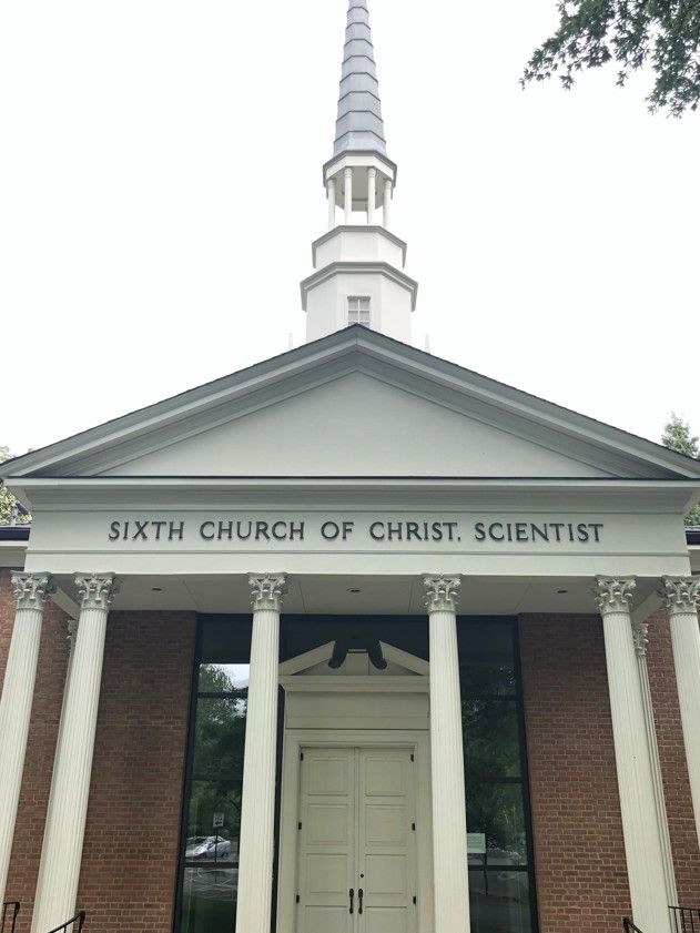 Front entrance of Sixth Church of Christ, Scientist, with white columns and a tall steeple