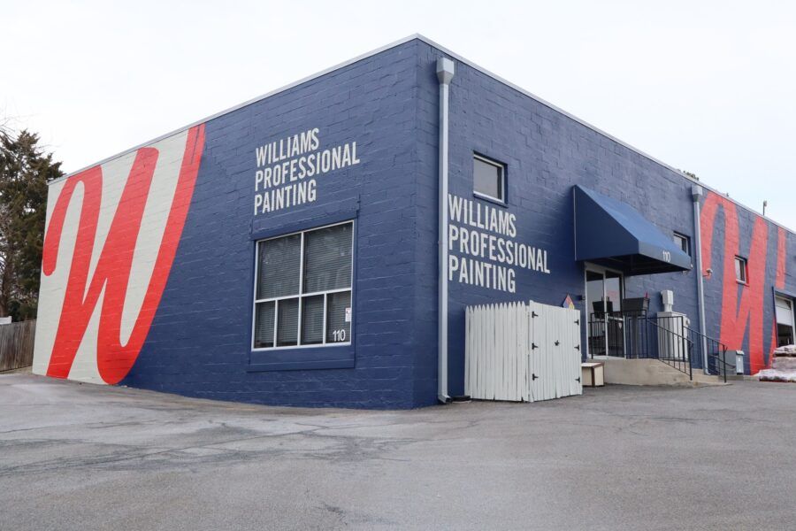 Blue building with large red “W” mural and “Williams Professional Painting” signage