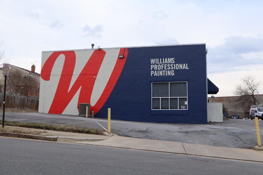 Blue building with a large red-and-white “W” and the sign “Williams Professional Painting”