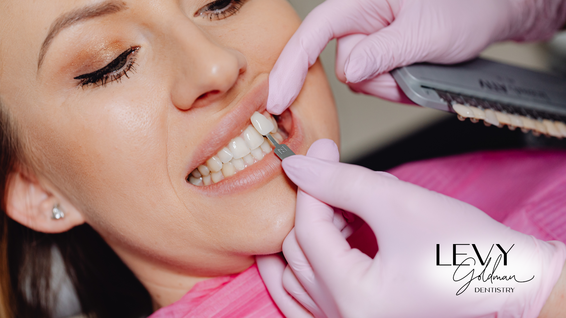 A woman is getting her teeth examined by a dentist.