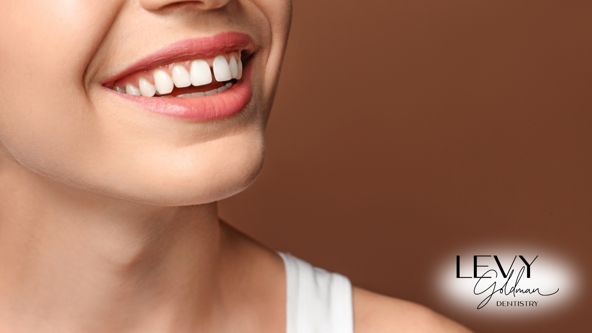 A close up of a woman 's smile with white teeth.