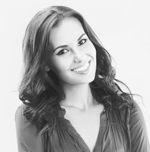 A black and white photo of a smiling woman