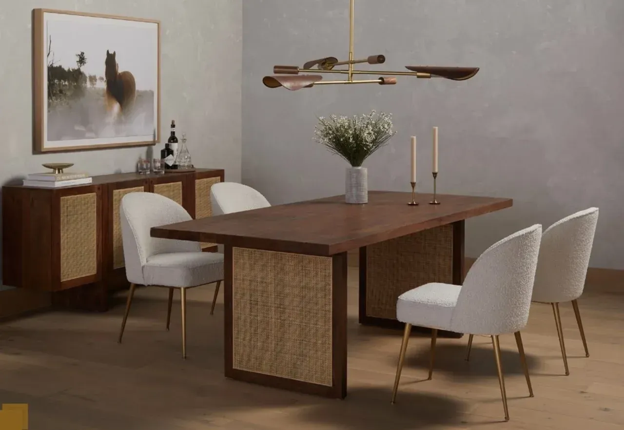 A dining room with a table and chairs and a picture on the wall.