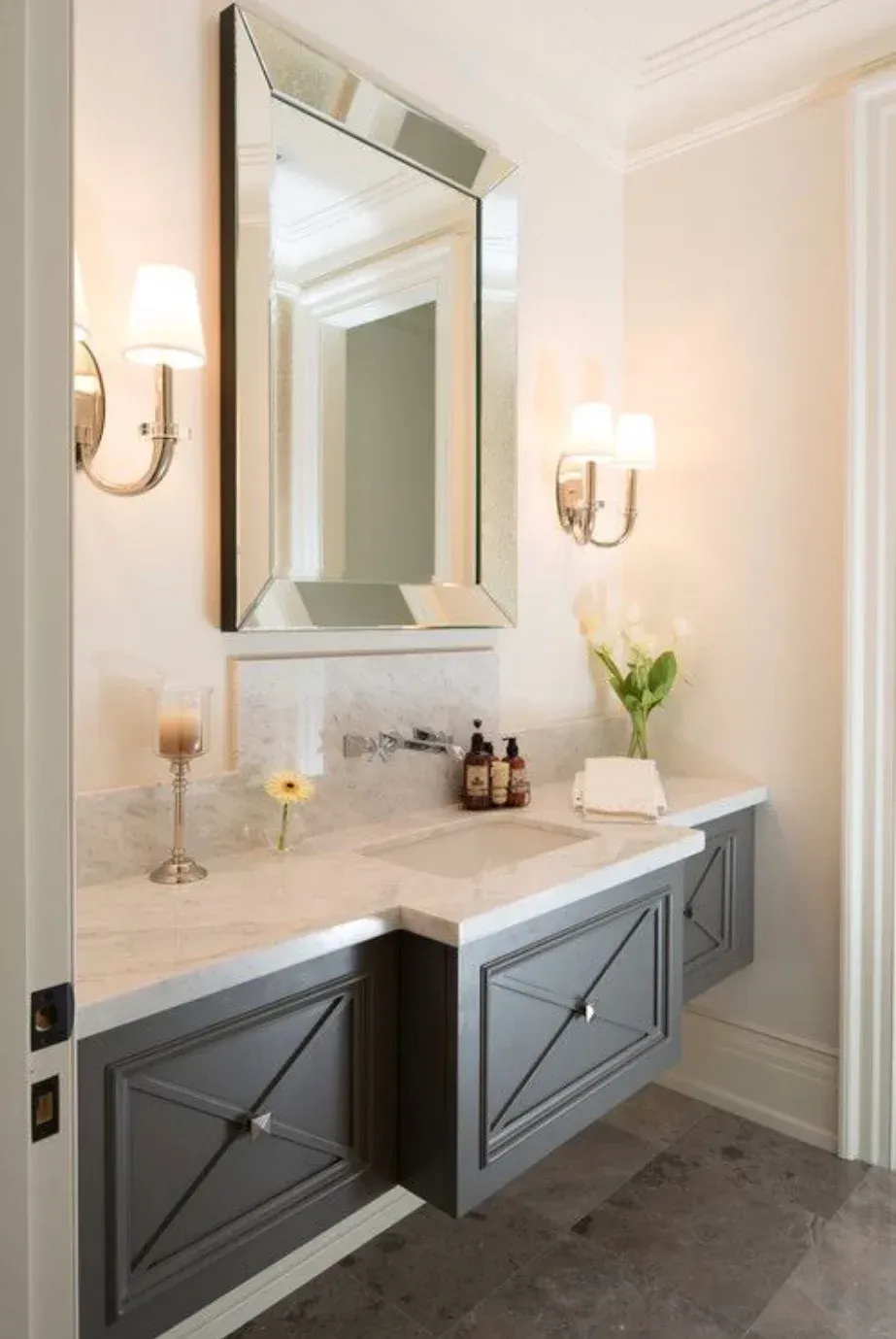 A bathroom with a sink and a mirror on the wall