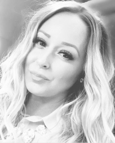 A black and white photo of a woman with long blonde hair.