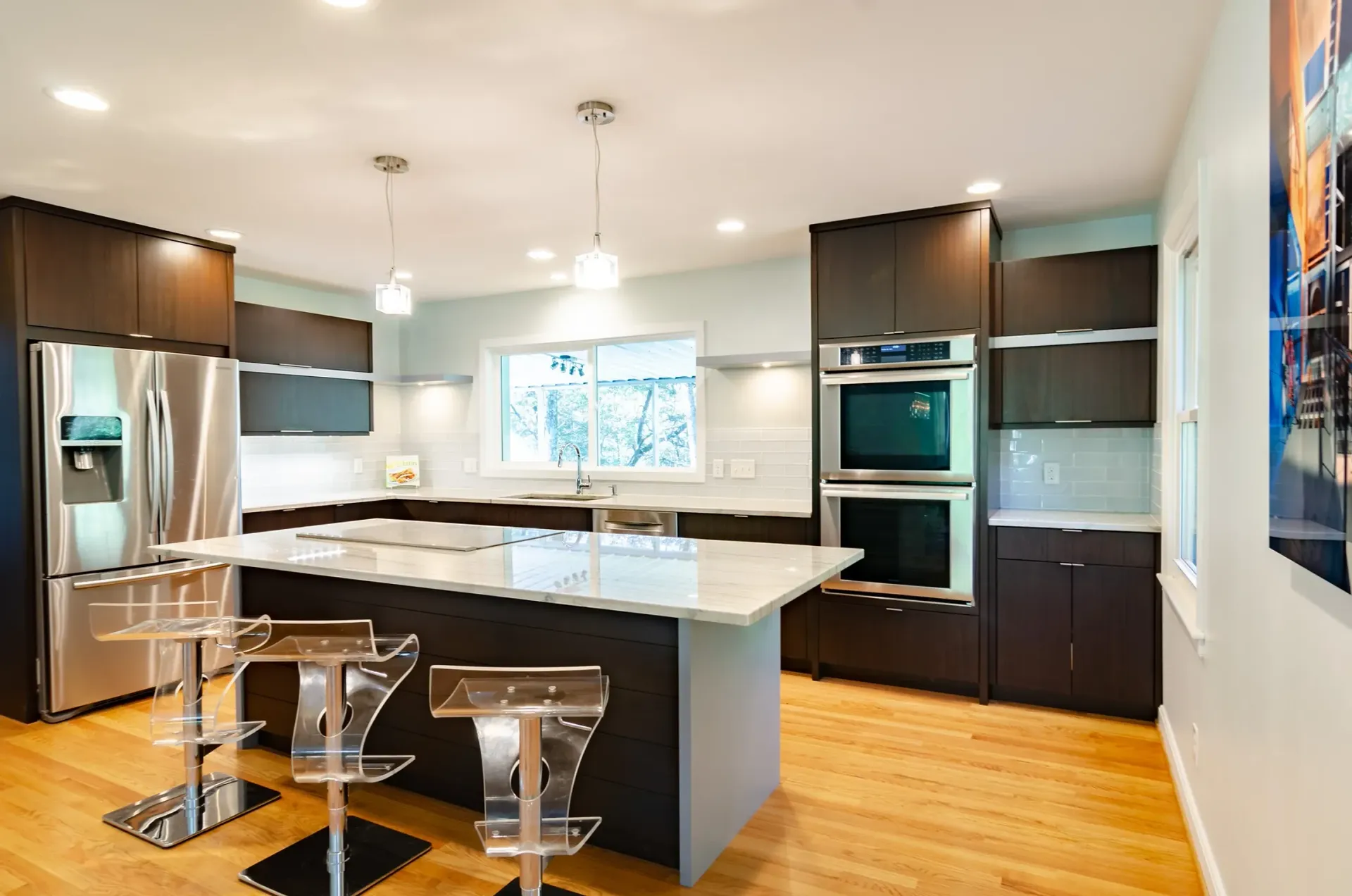 A kitchen with stainless steel appliances and a large island