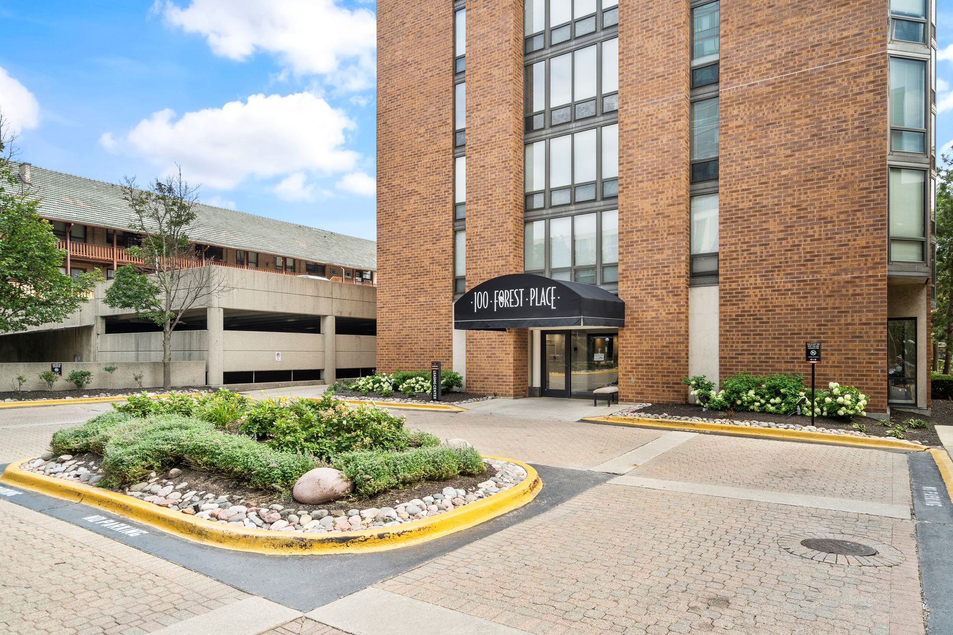 exterior view of the front entrance of 100 Forest Place Apartments in Oak Park, IL