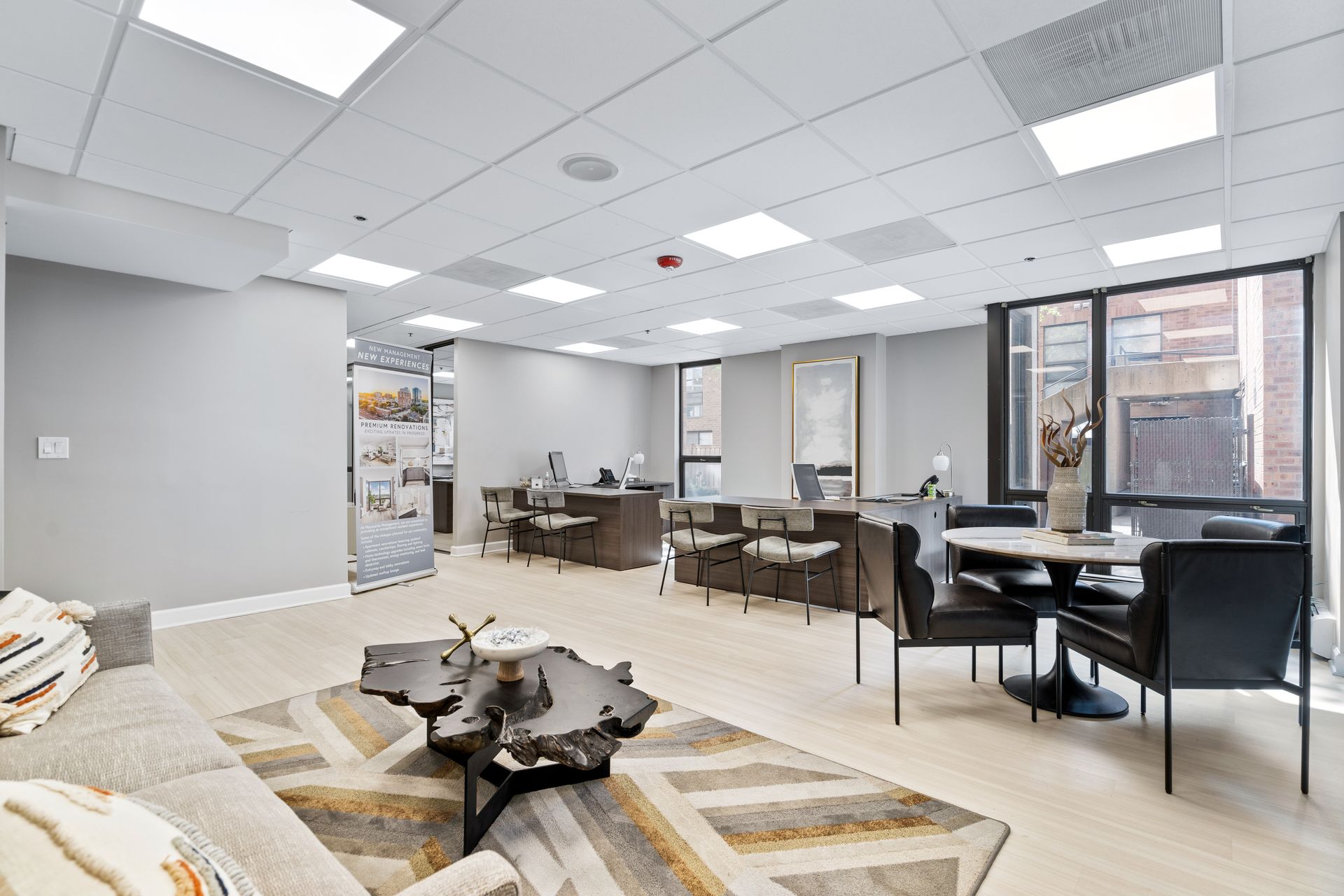 100 Forest Place Apartments leasing office with two desks, a couch, and a round table