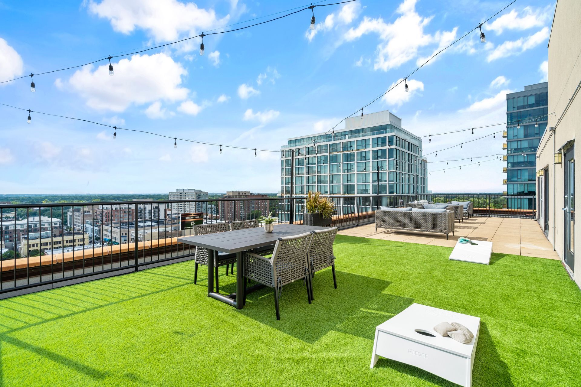 100 Forest Place Apartment's rooftop with a game lawn, dining area, and lounge area
