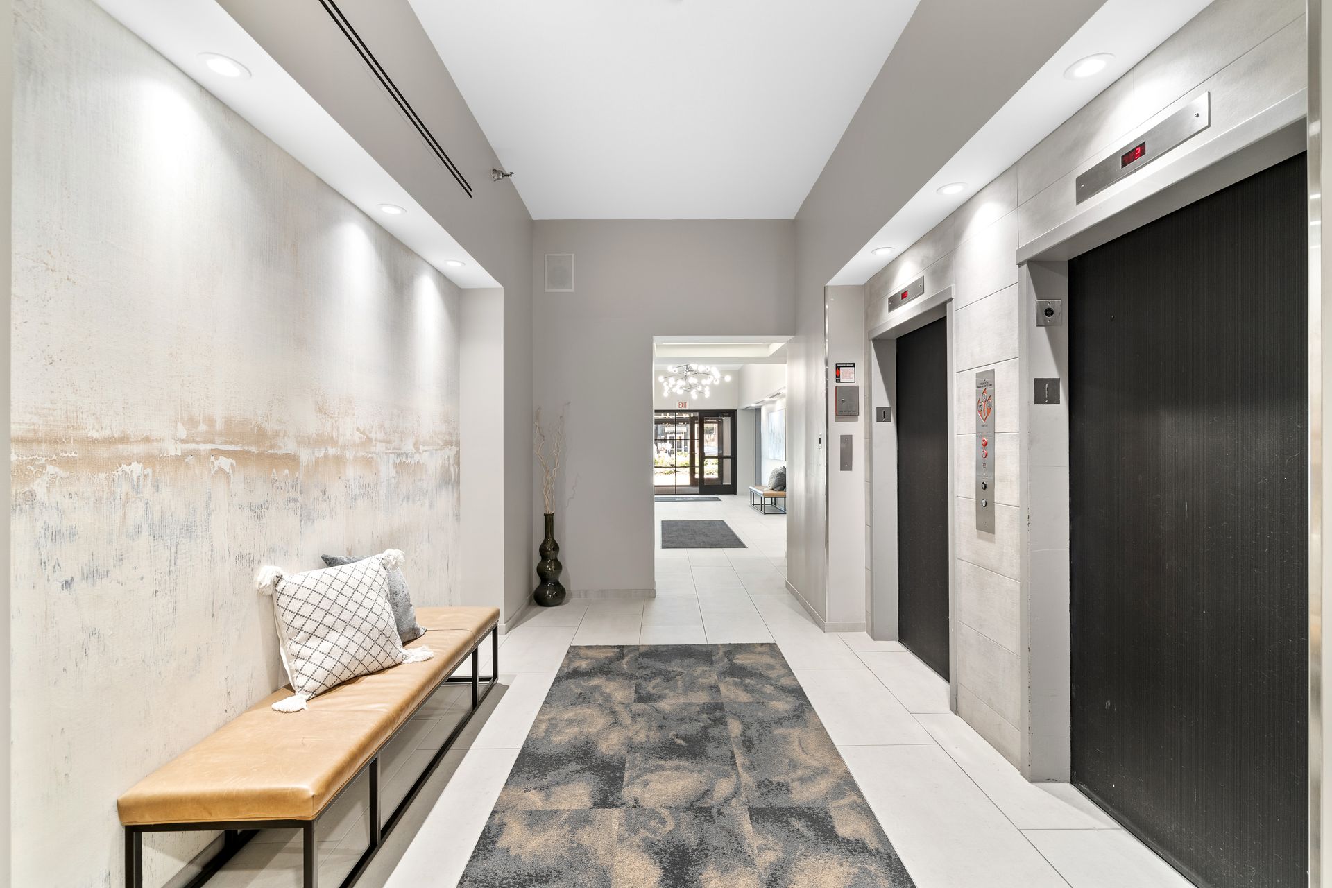 100 Forest Place Apartments hallway with two elevators and a bench with two pillows