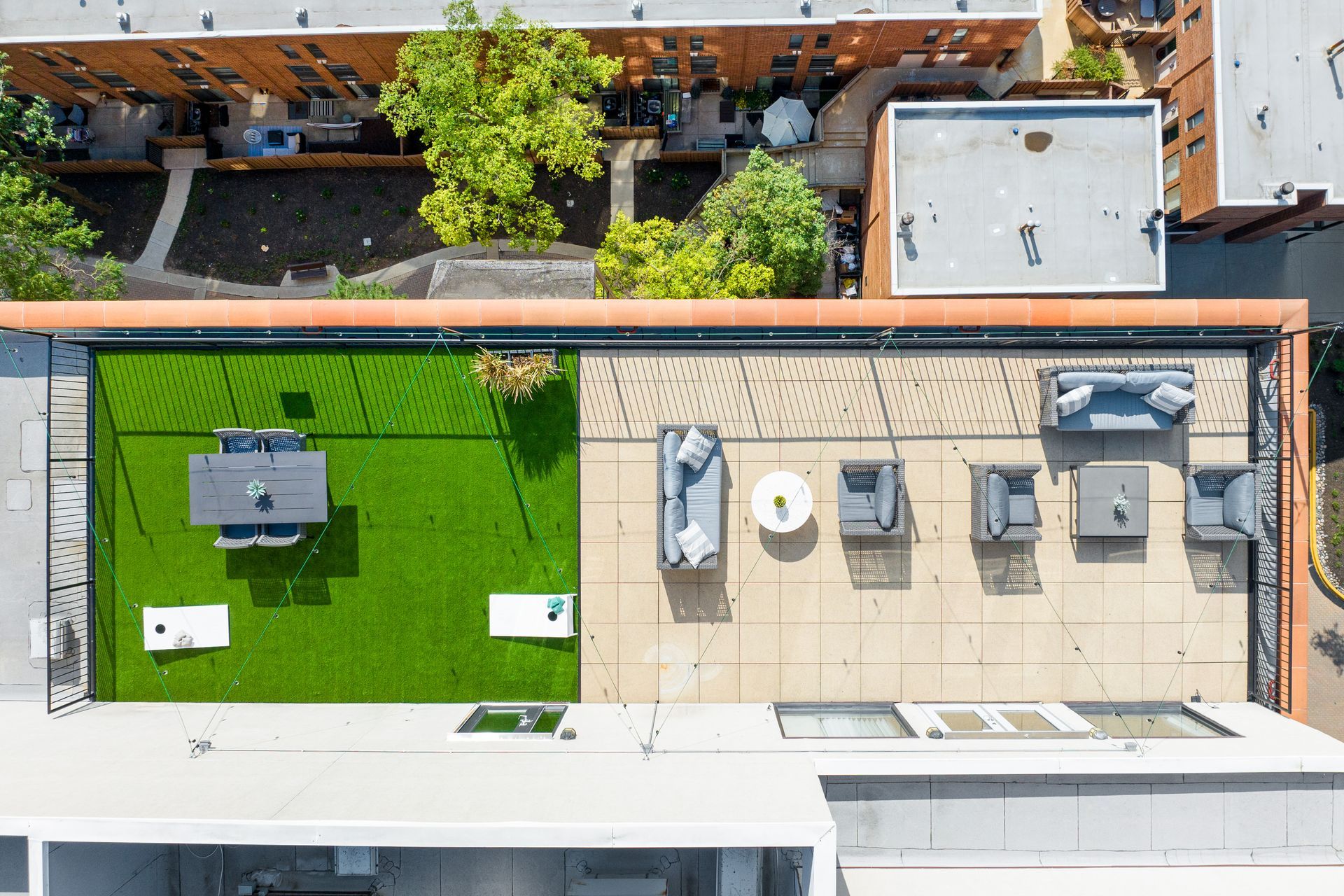 overhead view of 100 Forest Place Apartments rooftop lounge and game lawn
