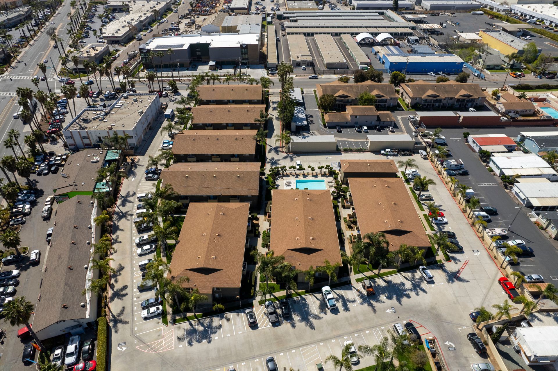 an aerial view of a residential area with a pool in the middle