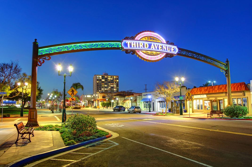 a sign for third avenue is lit up at night
