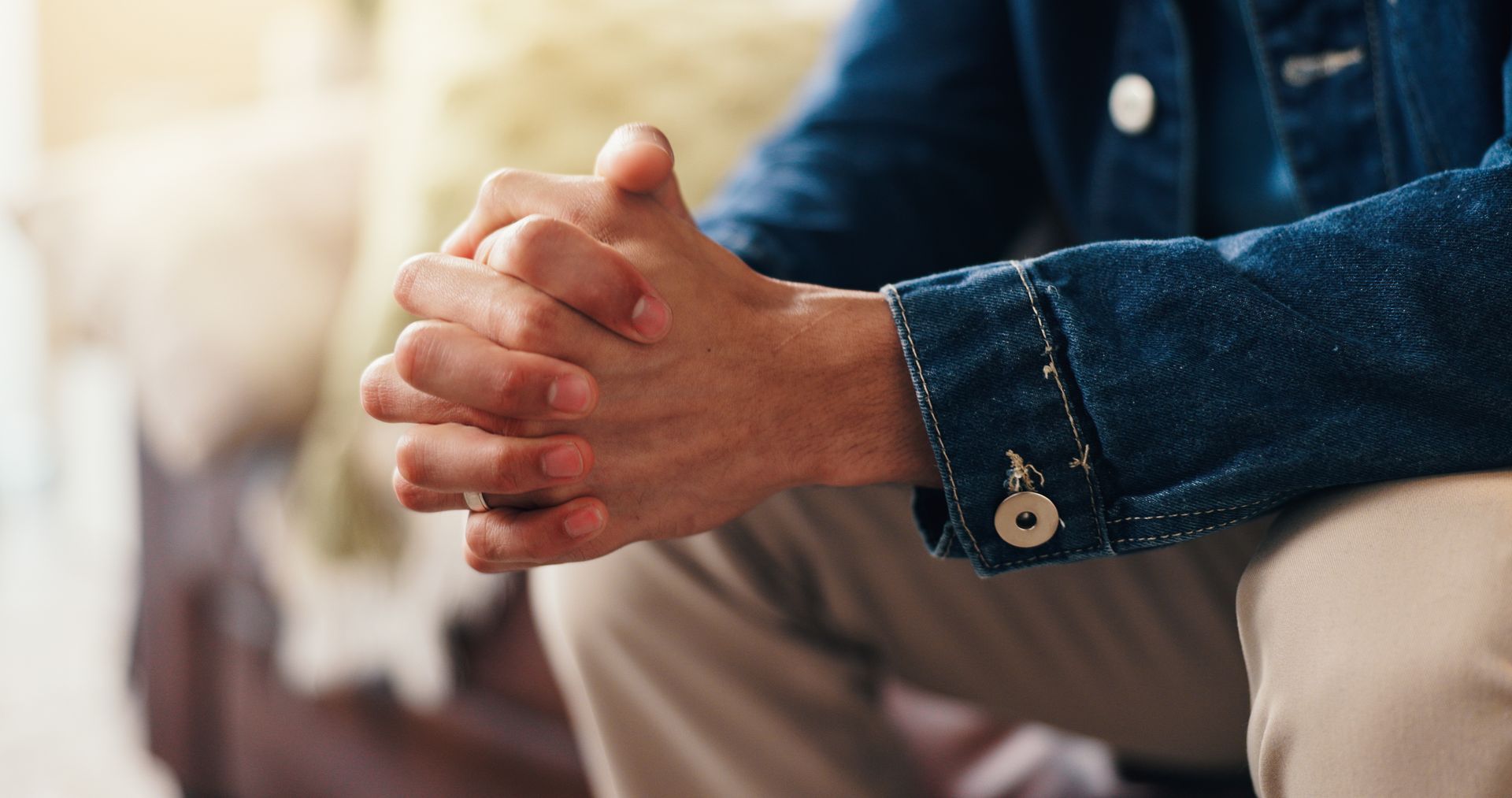 Hands, nervous and person in therapy for anxiety, counseling session or waiting for consultation. Ps