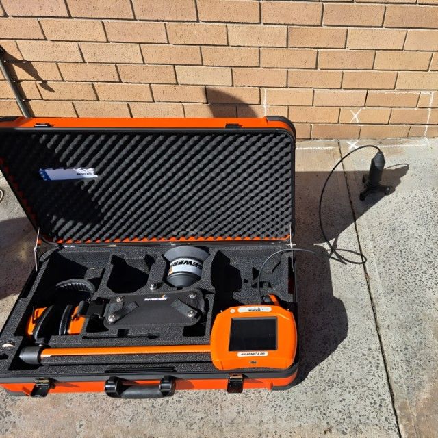 A Black and Orange Radar Set With a Device Inside of It — Dowds Pipe and Cable Locating in Farmborough Heights, NSW