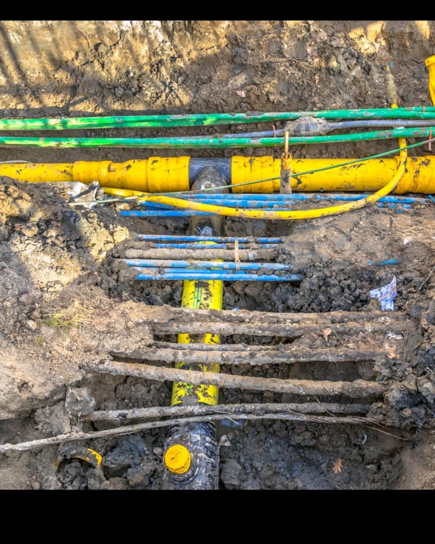 A Bunch of Electrical Wires Are Laying in the Dirt — Dowds Pipe and Cable Locating in Moss Vale, NSW