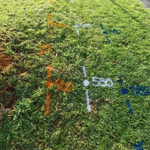 A Field of Grass With Numbers Painted on It — Dowds Pipe and Cable Locating in Bondi, NSW
