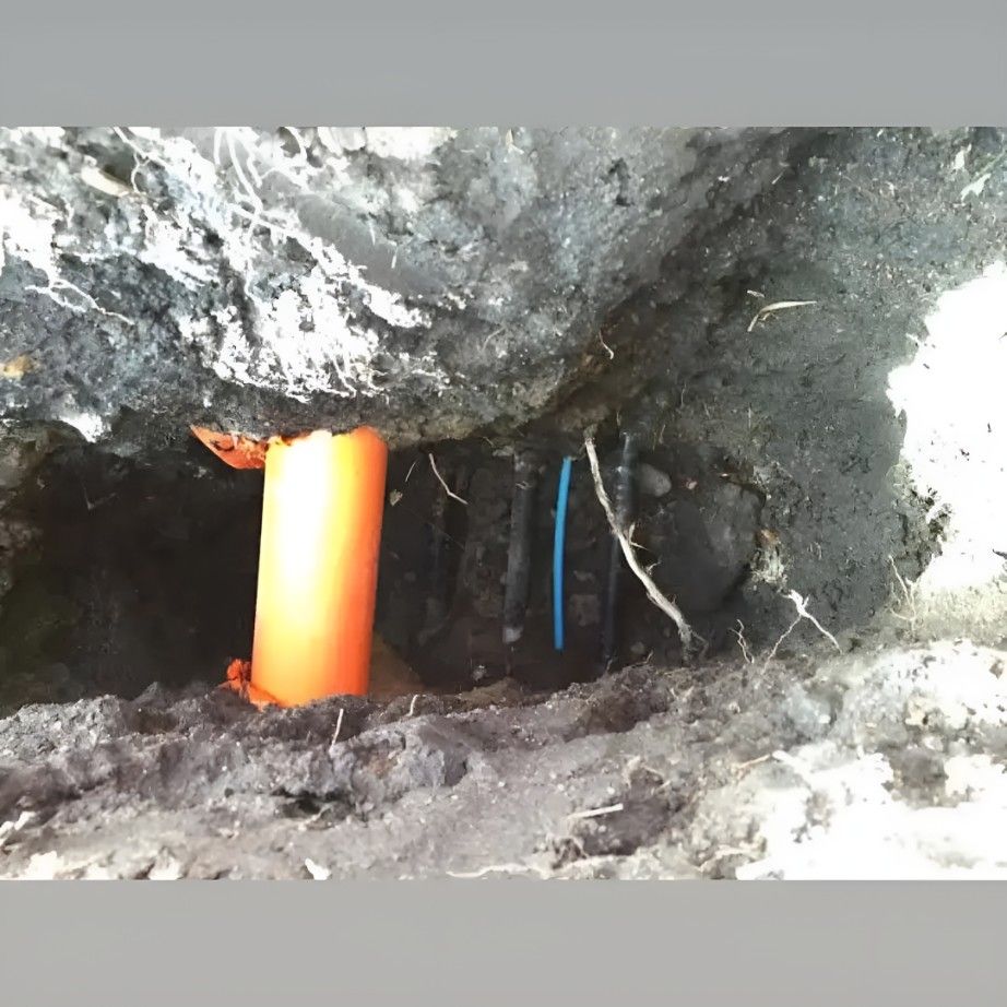 A Hole in the Ground With an Orange Pipe in It — Dowds Pipe and Cable Locating in Vincentia, NSW