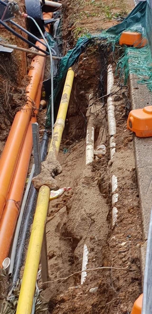 A Bunch of Pipes Are Laying in the Dirt — Dowds Pipe and Cable Locating in Penrith, NSW